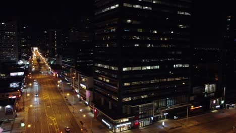 Night-time-aerial-orbit-around-business-office-district-in-downtown