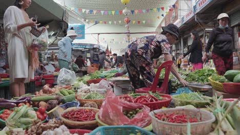 Local-vendors-and-traditional-stalls-selling-fresh-fruits,-and-vegetables,-textiles,-and-clothes-at-the-famous,-busy-and-colorful-Con-Market-in-Danang,-Vietnam-in-Asia