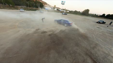 FPV-drone-orbits-a-Mustang-ripping-up-the-desert-while-a-man-does-tricks-with-a-soccer-ball