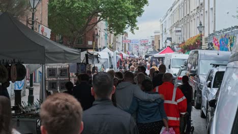 Crowd-Of-People-Walking-In-Narrow-Street-At-Portobello-Road-Market-In-London,-UK