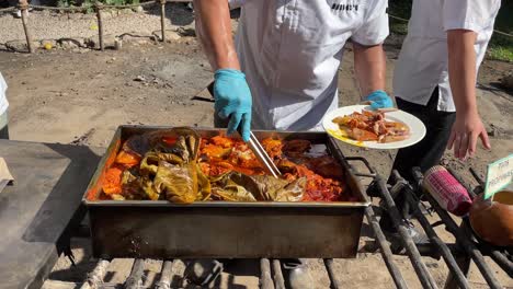 slow-motion-shot-of-chefs-serving-the-tray-of-cochinita-pibil-in-merida-yucatan-mexico