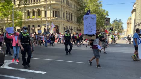 Protesters-rally-in-Melbourne-Australia-walking-down-Collins-Street-stopping-all-traffic,-protesting-against-Dan-Andrews