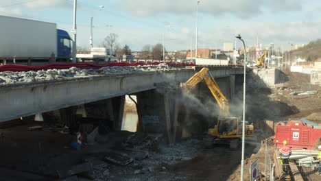 Demolition-excavator-drill-machine-dismantling-concrete-highway-bridge
