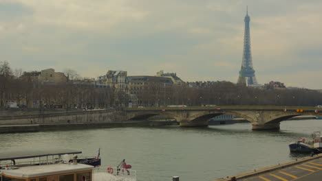 Scenic-View-Of-An-Old-Bridge-Over-The-Seine-River-With-Eiffel-Tower-In-Background-In-Paris,-France