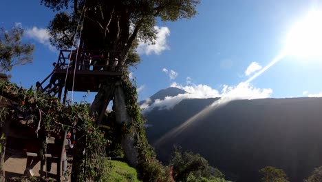 People-visiting-the-famous-Swing-at-the-End-of-the-World-in-Baños,-Ecuador-located-in-front-of-Tungurahua-Volcano