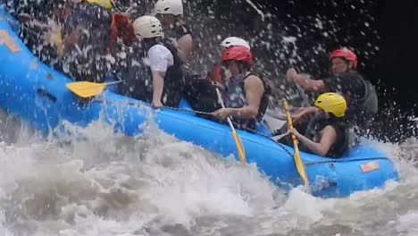 A-group-of-tourists-is-rafting-and-encounters-a-strong-river-with-big-waves