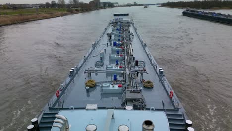 Aerial-view-over-liquid-tanker-ship-navigating-through-the-inland-canal-of-Zwijndrecht,-The-Netherlands