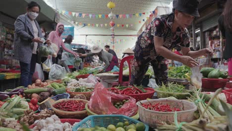 Local-vendor-and-traditional-stalls-selling-fresh-fruits,-and-vegetables,-textiles,-and-clothes-at-the-famous,-busy-and-colorful-Con-Market-in-Danang,-Vietnam-in-Asia