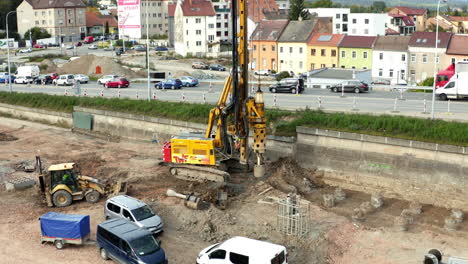 Hydraulic-drilling-machine-working-at-construction-next-to-car-traffic