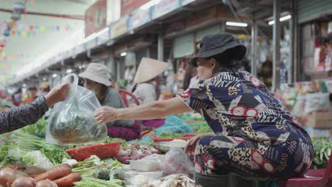 Local-vendors-and-traditional-stalls-sell-fresh-foods,-fruits,-vegetables,-and-clothes-at-busy-and-colorful-Con-Market-in-Danang,-Vietnam