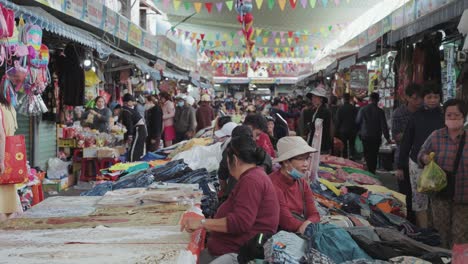 Local-vendors-and-traditional-stalls-selling-textiles-and-clothes-at-busy-and-colorful-Con-Market-in-Danang,-Vietnam-in-Asia