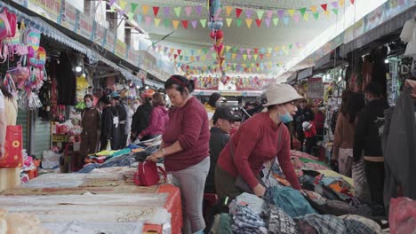 Local-vendors-sell-textiles-and-clothes-at-busy-and-colorful-Con-Market-in-Danang,-Vietnam-in-Asia
