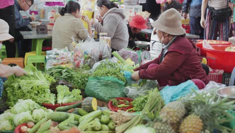 Local-vendor-and-traditional-stall-selling-fresh-fruits-and-vegetables,-at-busy-and-colorful-Con-Market-in-Danang,-Vietnam