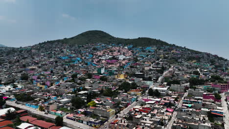 Drone-shot-toward-the-Dr-Simi-face-landmark-in-the-mountains-of-Ecatepec-de-Morelos,-Mexico