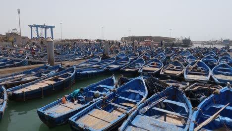 Colorful-blue-boats-docked-in-filled-harbor