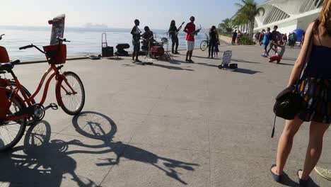 People-watching-a-street-band-at-Praca-Maua,-at-sunset,-in-the-center-of-Rio-de-Janeiro,-Brazil