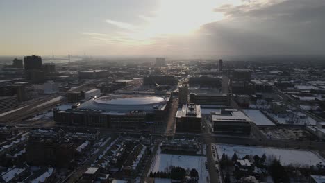 Sports-arena-and-downtown-of-Detroit-with-snow-storm-coming,-aerial-view