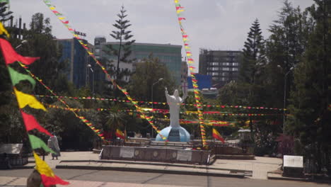 Statue-in-front-of-the-holy-trinity-cathedral-in-Addis-Ababa-Ethiopia-with-red-green-and-yellow-flags