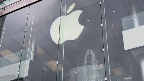 Customers-shop-at-the-American-technology-brand,-Apple,-official-store-and-company-logo-in-Hong-Kong