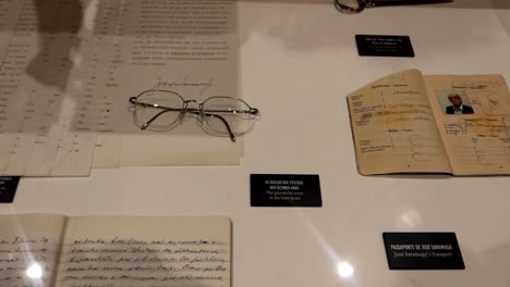Jose-Saramago-personal-items-in-a-display-cabinet-with-glasses-and-writing