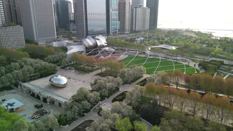 Aerial-pan-of-Cloud-Gate-and-Jay-Pritzker-Pavillion,-Chicago