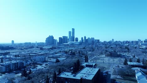 Edmonton-Downtown-City-Center-drone-flyover-North-to-South-residential-to-skyscrapers-mirrored-reflective-towers-hotels-condos-office-building-on-clear-sunny-day-overlooking-birds-top-view-of-metro1-4