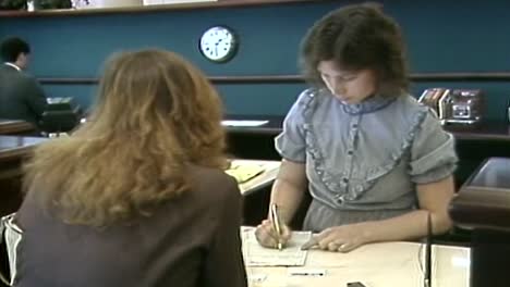 BANKER-FILLING-OUT-PAPER-WORK-IN-1980S