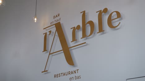 Closeup-shot-of-artistic-L'arbre-restaurant-logo-in-Montpellier