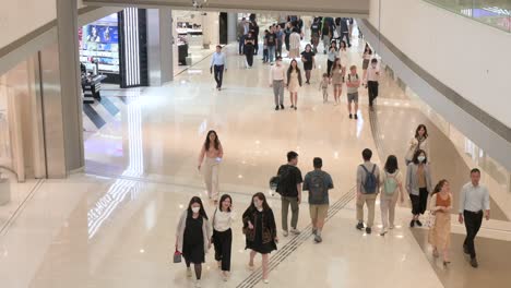 Shoppers-stroll-through-a-high-end-shopping-mall-as-they-window-shop-and-buy-renowned-brand-products