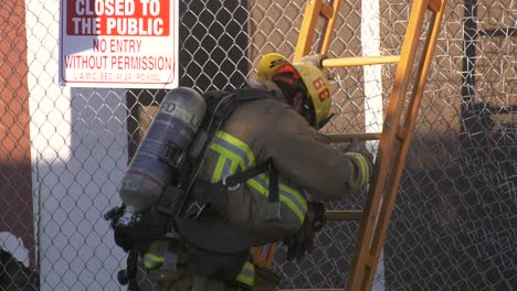 firefighter-walks-down-ladder-at-fire