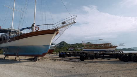 Man-busy-on-deck-of-yacht-in-Simena-dry-dock-preparing-for-tourist-season