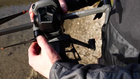 Unfolding-Arms-of-DJI-Mavic-3-Pro-Drone-With-Triple-Camera,-Close-Up-50fps