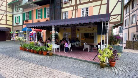 Traditional-French-Café-with-people-having-lunch,-breakfast-at-Colmar-Tropicale-,-Bukit-Tinggi-Malaysia