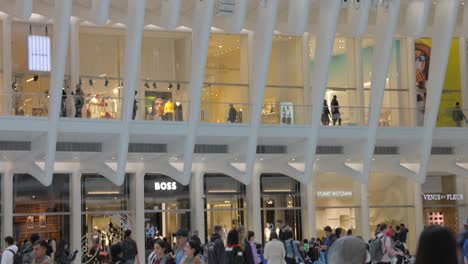 Commuters-and-people-shopping-in-famous-stores-of-Oculus-Mall,-World-Trade-Center-Path-station,-New-York,-USA