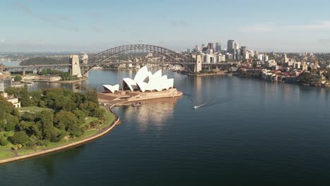 Sydney,-New-South-Wales,-Australia---25-December-2021:-Aerial-view-of-the-Sydney-Opera-House-with-the-Sydney-Botanical-Gardens-in-the-foreground-and-Sydney-Harbour-Bridge-in-background