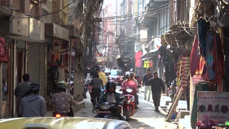 Shot-of-traffic-in-Small-street-of-Kathmandu-With-Cars-and-Nepalese-people-Walking-Nepal