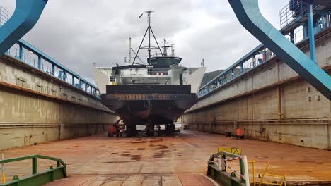 Walking-towards-hydrogen-powered-passenger-ferry-HYDRA-while-inside-drydock-at-Westcon-ship-repair-Norway