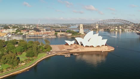 Sydney,-New-South-Wales,-Australia---25-December-2021:-Aerial-view-of-Government-House-in-the-Sydney-Botanical-Gardens-and-the-Sydney-Opera-House-as-the-view-moves-across-Sydney-Harbour