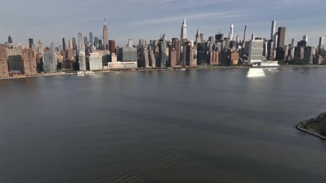 A-high-angle-aerial-establishing-shot-of-the-east-side-of-Manhattan,-NY-on-a-sunny-day