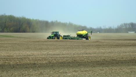 John-Deere-tractor-and-air-seeder-planting-a-field-on-a-sunny-dry-spring-day-in-Northern-Ontario