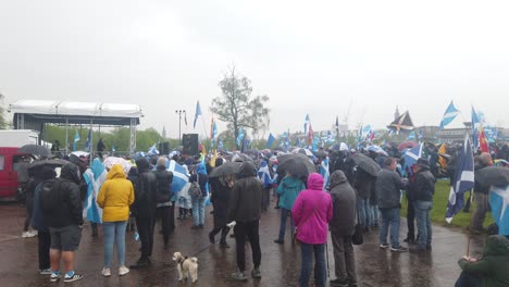 Wide-shot-of-supporters-listening-to-speakers-in-the-rain-at-Glasgow-Green