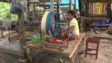 Wide-Shot-Of-Femaile-Traditionally-Spinning-Thread-in-Thailand---Kanchanaburi