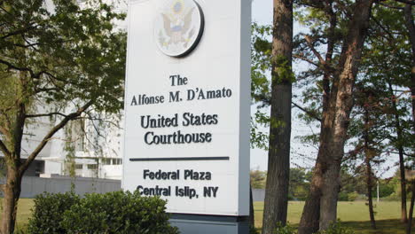 Central-Islip-New-York-Federal-Courthouse-Exterior-Entrance-Sign-Panning-Shot-to-flag