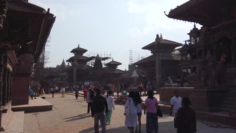 Pan-Shot-In-Patan-Temples-with-People-Walking-and-visiting,-locals-and-foreigners-during-sunny-day,-Kathmandu-Nepal