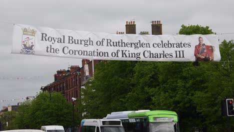 Close-up-of-a-banner-of-King-Charles-III-at-a-busy-junction