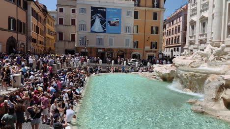 Lateral-motion-time-lapse-with-tourists-gathering-around-the-Trevi-Fountain-on-a-beautiful-sunny-day
