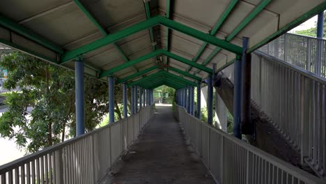 Perspective-view-of-a-covered-bridge-in-Ah-Hood-Gardens,-Balestier,-Singapore