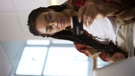 Junger-Afroamerikaner-Hält-Kreditkarte-Mit-Laptop-In-Der-Hand-Und-Kauft-Online,-Aus-Nächster-Nähe