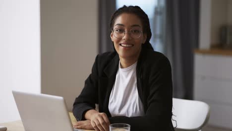 Black-girl-secretary-business-woman-sitting-at-table-at-office,-portrait-footage