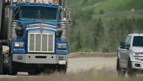 Kenworth-slowly-drives-by-on-highway-near-Dunvegan-Alberta